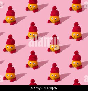 Fruit seamless pattern of funny tangerines in hats on pink background Stock Photo