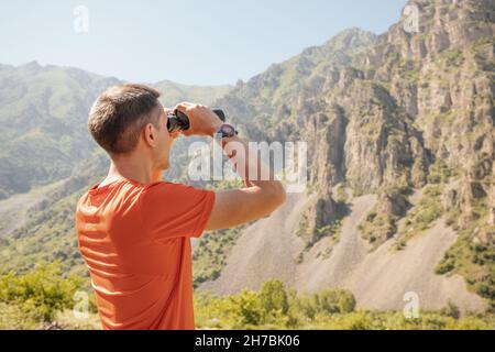 A male ranger inspects the boundaries of a nature reserve or national park to detect smoke from fires or animals Stock Photo