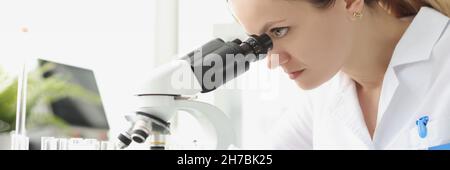 Adult caucasian beauty woman chemist looking at microscope Stock Photo