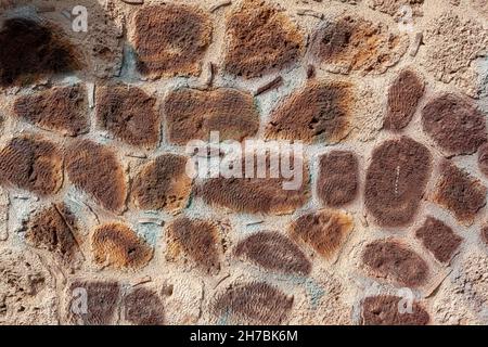 Smooth wall of old porous blocks of different sizes on cement mortar. Stock Photo