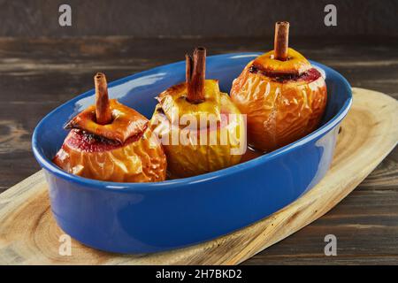 Oven baked apples stuffed with dried fruits and cinnamon. French gourmet cuisine Stock Photo
