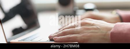 Female hands typing on laptop keyboard closeup Stock Photo