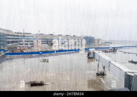 View of Domodedovo International Airport territory through the rain watered stained window. DME, Moscow, Russia Stock Photo