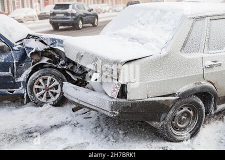 St-Petersburg, Russia - February 22, 2018: Crashed cars in an accident stands on a snowy winter street Stock Photo