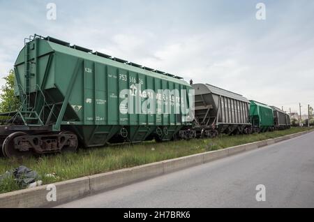 St-Petersburg, Russia - June 8, 2017: Green industrial cargo railway cars stand on a railroad on a daytime Stock Photo