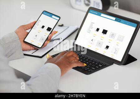 Woman shopping online, browsing internet store website on tablet and using app on mobile phone Stock Photo