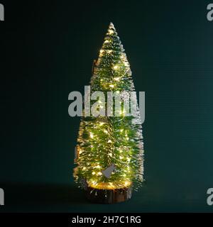 Deccorated Christmas tree on green background. Space for text Stock Photo