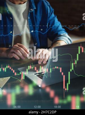 Trader at home, working on laptop with graphs and diagrams. Business man analyzing indexes, financial chart, trading online, investment data on crypto Stock Photo