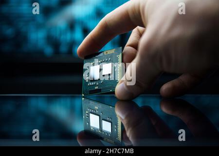 Computer chip in hands. A chipset is a set of electronic component that is integrated and flows data between the processor. Chipsets usually work with Stock Photo