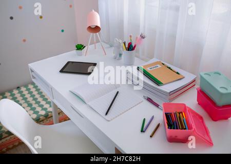 Desk in girl's bedroom decorated in pastel colors Stock Photo