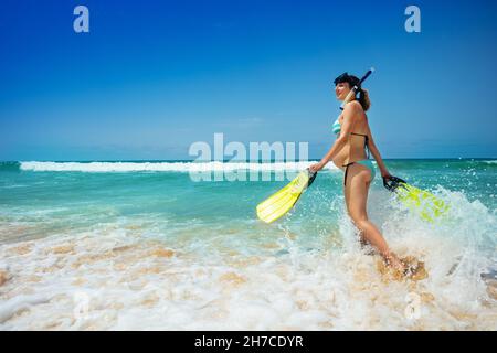Pregnant woman walk in sea to snorkel with mask Stock Photo