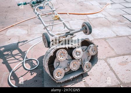 polishing machine for adhesive cleaning and leveling of cement surfaces - such as floors and rough tiles on the street. Stock Photo