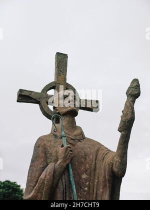 The St Aidan statue in Parish Church of Saint Mary the Virgin graveyard on Holy Island Northumberland England UK Stock Photo