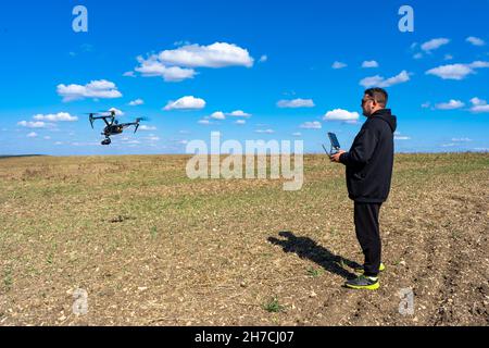 The pilot controls a professional drone Stock Photo