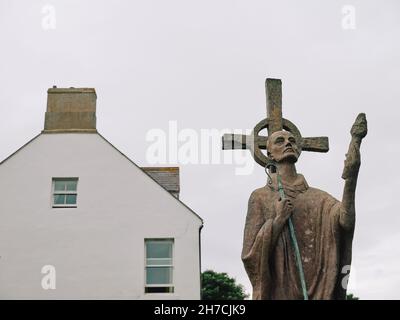 The St Aidan statue in Parish Church of Saint Mary the Virgin graveyard on Holy Island Northumberland England UK Stock Photo