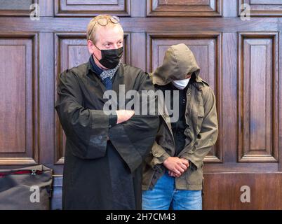 Hamburg, Germany. 22nd Nov, 2021. A 19-year-old defendant (r) stands next to his defense lawyer Axel Max in the regional court. Because he allegedly stabbed a 14-year-old teenager with several knives, the young man must now answer to the Hamburg Regional Court.(to dpa 'Stabbing of 14-year-old - defendant not yet able to speak') Credit: Daniel Bockwoldt/dpa/Alamy Live News Stock Photo