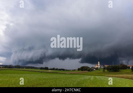 approaching thunderstorm over Bavarian cultural landscape, Germany, Bavaria, Voralpenland, Hoeselwang Stock Photo
