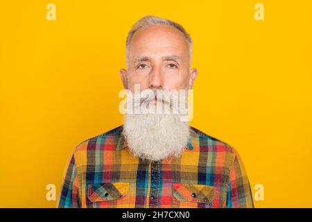 Photo of handsome confident mature man mustache strict wear casual shirt isolated over yellow color background Stock Photo