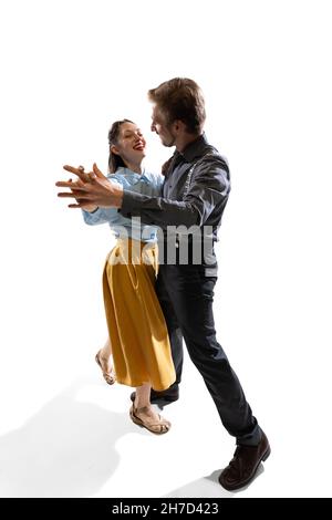 Close-up two people, young man and woman in vintage attire dancing retro dance isolated on white background Stock Photo