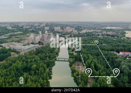 Topographic plot of land for rent. Lease of land with trees near the river in the city. Land for development. Land for sale and investment: Aerial drone shot. Stock Photo