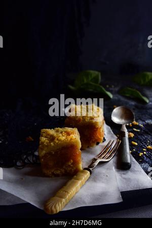 Sweet dessert, two pieces of apple cake on a black background in the morning. Stock Photo