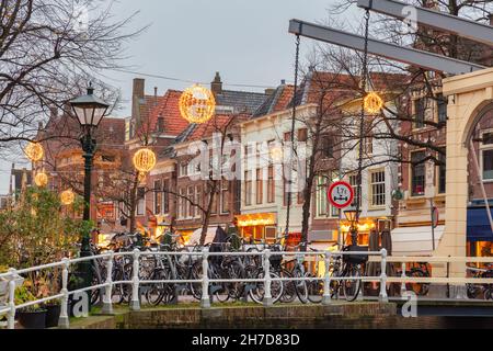 Evening view of a canal bridge with christmas decoration in the historic city center of the Dutch city of Alkmaar Stock Photo