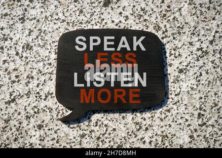 Quote bubble with phrase speak less listen more. Stock Photo