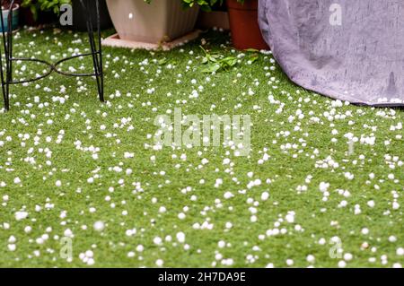 Hail rocks on the (synthetic) lawn. Photographed in Tel Aviv, Israel in May Stock Photo