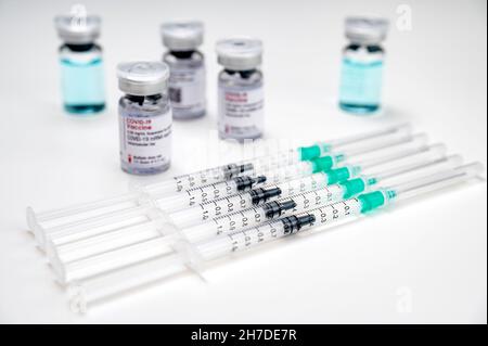 Coronavirus vaccination against SARS-CoV-2 – medical syringes with COVID-19 vaccine and different glass vials in the background. Stock Photo