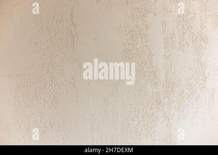 Pale beige matt plaster wall close-up. Decorative Venetian plaster. Stock Photo