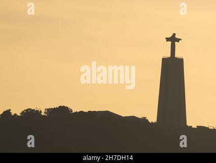 Lisbon at sunset, silhouette of the statue of Christ the King. Portugal Stock Photo