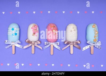 top view of decorated cake pops ice creams on violet background Stock Photo