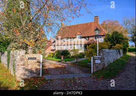 Mill Cottage, Halnaker, is an old house with brickwork and half-timbering on Stane Street, the old Chichester to London Roman Road. Sussex, England. Stock Photo