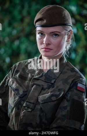 Portrait of a young lady soldier in military clothing while on duty. Stock Photo