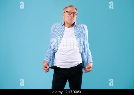 Portrait of mature man showing his empty pockets Stock Photo