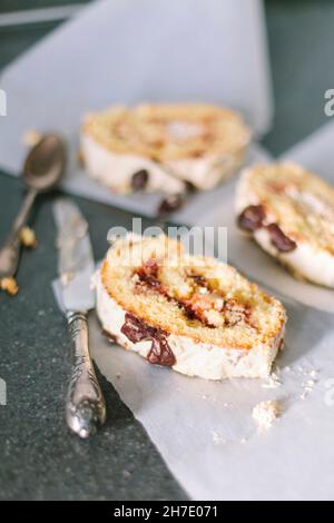 Biscuity roll with fruit and chocolate filling on a white parchment Stock Photo