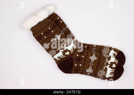 Beautiful winter warm Christmas socks with a New Year's pattern on a white background. Sweet Greeting gift. Original design and texture. Best Stock Photo