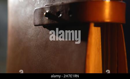 Vintage books with leather bound, close-up. Close-up of old leather bound book with the leather straps in the dark room. Stock Photo