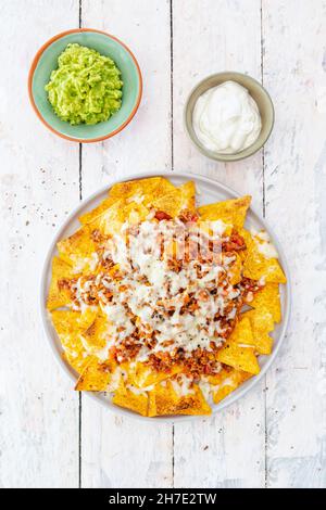 Nachos with minced meat, guacamole and sour cream (Mexico) Stock Photo