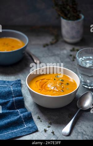 Roasted butternut squash soup with chili oil and thyme Stock Photo