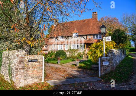 Mill Cottage, Halnaker, is an old house with brickwork and half-timbering on Stane Street, the old Chichester to London Roman Road. Sussex, England. Stock Photo
