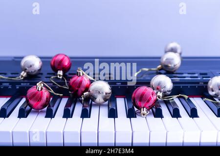 A colorful chain of lights lies on piano keys Stock Photo