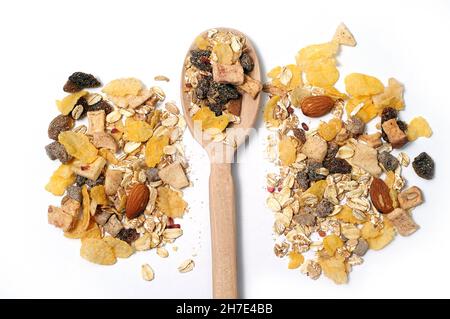Mixture of oat flakes with fruits, with wooden spoon in the middle Stock Photo