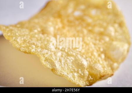 A single potato chip (close-up) Stock Photo
