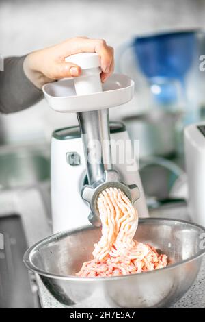 cooking minced meat at home using a meat grinder Stock Photo