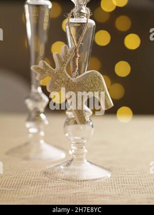A candlestick holder with a golden reindeer figure on a festively set table Stock Photo