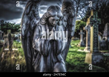 Mysterious dark and moody Angel Praying Stock Photo - Alamy