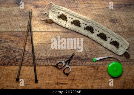 Long white and patterned knitted swatch testing with knitted piece Stock Photo