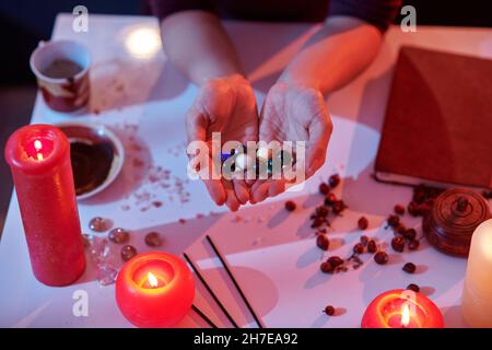 Spiritual healer holding mixed healing crystals in cupped hands Stock Photo