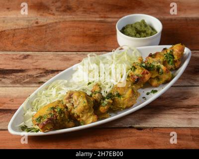 Murgh bangara kebab on wooden background. Dishes and appetizers of indian cuisine, selective focus Stock Photo
